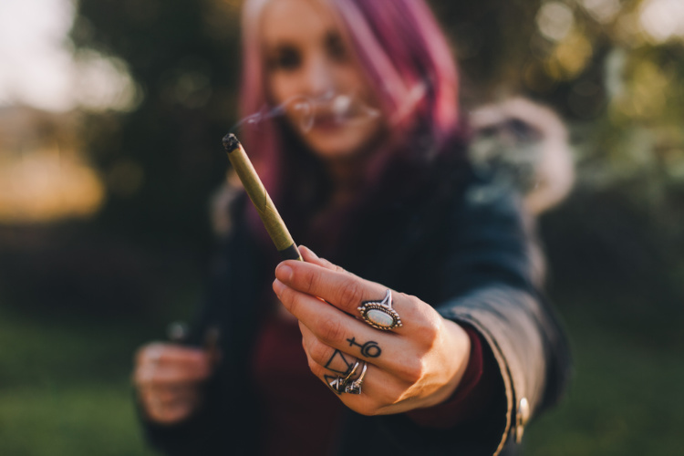how to stop being high woman holding out joint