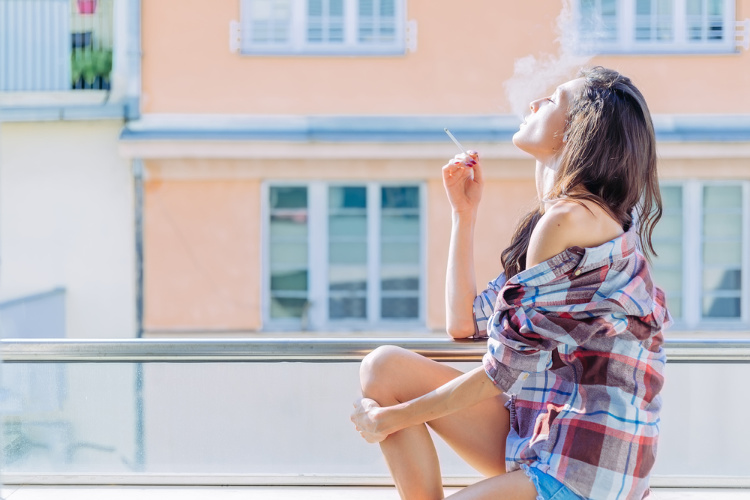 Cannabis Friendly hotels woman enjoying a smoke